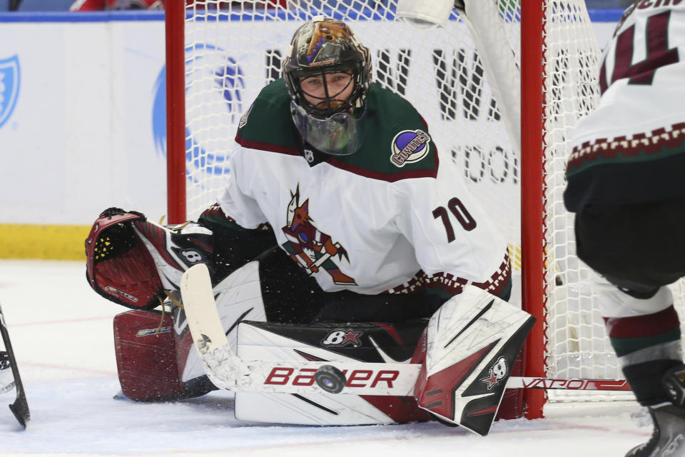 Arizona Coyotes goalie Karel Vejmelka (70) makes a save during the first period of an NHL hockey game against the Buffalo Sabres, Saturday, Oct. 16, 2021, in Buffalo, N.Y. (AP Photo/Jeffrey T. Barnes)