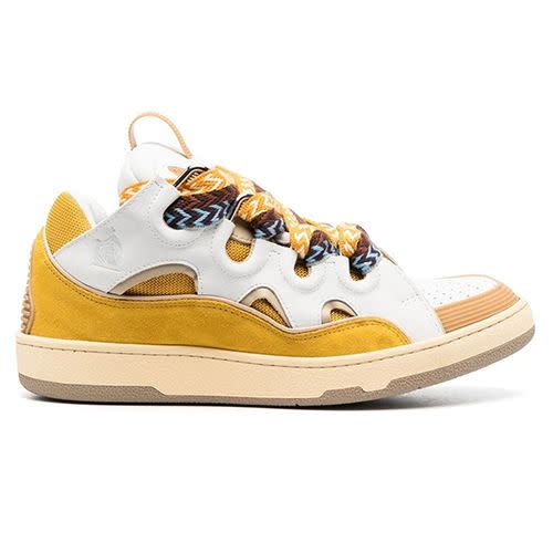 <p><a class="link " href="https://www.farfetch.com/uk/shopping/men/lanvin-curb-low-top-sneakers-item-19038355.aspx?storeid=9870" rel="nofollow noopener" target="_blank" data-ylk="slk:SHOP;elm:context_link;itc:0;sec:content-canvas">SHOP</a></p><p>Since its debut at PFW AW20, the Lanvin Curb sneaker – a crep palpably inspired by Noughties skateboarding kicks from the likes of DC and Osiris – has been the ultimate It-shoe. And for AW22, the Parisian fashion house is keeping up the momentum with this very ‘it’s fall, y’all’ warm yellow colourway. </p><p>£720; <a href="https://www.farfetch.com/uk/shopping/men/lanvin-curb-low-top-sneakers-item-19038355.aspx?storeid=9870" rel="nofollow noopener" target="_blank" data-ylk="slk:farfetch.com;elm:context_link;itc:0;sec:content-canvas" class="link ">farfetch.com</a></p>