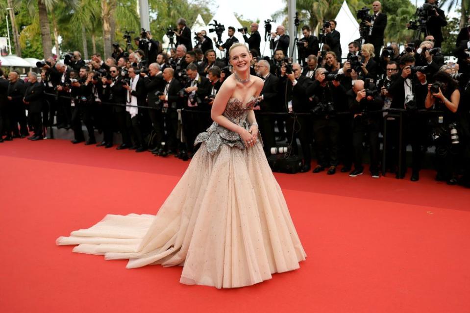<p>Elle Fanning wore a fairy-tale strapless Alexander McQueen gown with Cartier jewellery to attend the opening ceremony and premiere of Jeanne du Barry.</p>