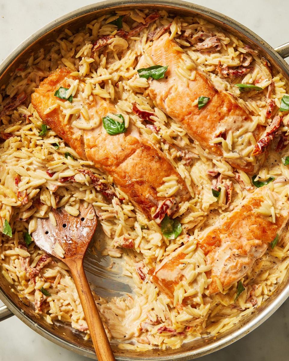 creamy sundried tomato salmon orzo topped with fresh basil