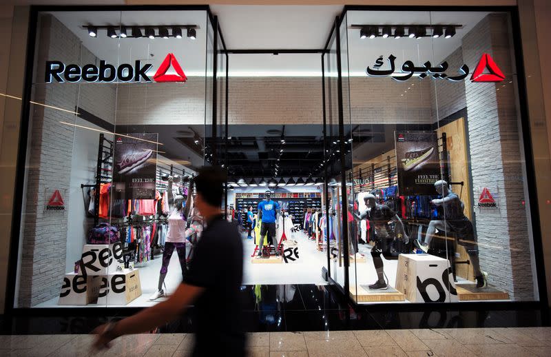 A man walks in front of the Reebok store at Bahrain City Center in Manama