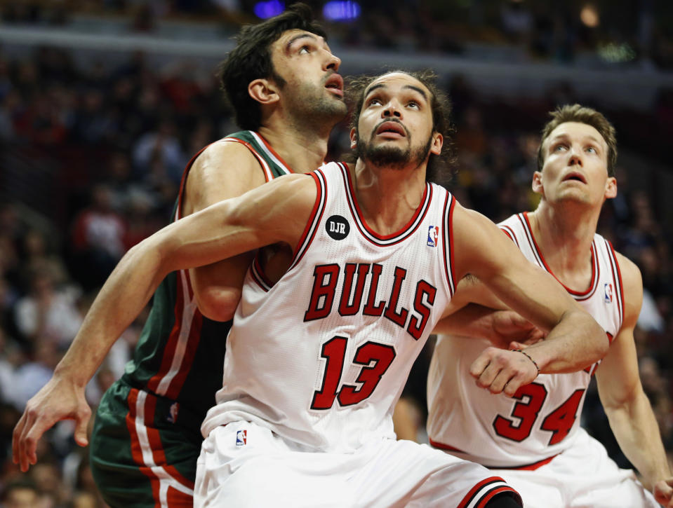 FILE - In this April 4, 2014 file photo, Chicago Bulls center Joakim Noah (13) defends against Milwaukee Bucks center Zaza Pachulia during an NBA basketball game in Chicago. A person familiar with the situation says that Noah is the NBA's Defensive Player of the Year. The person spoke Monday, April 21, 2014 on the condition of anonymity because the award had not been announced. (AP Photo/Kamil Krzaczynski, File)