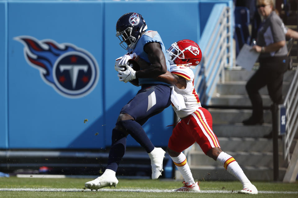 Tennessee Titans wide receiver A.J. Brown, left, catches a touchdown pass as he is defended by Kansas City Chiefs cornerback Mike Hughes, right, in the first half of an NFL football game Sunday, Oct. 24, 2021, in Nashville, Tenn. (AP Photo/Wade Payne)