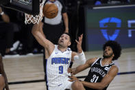 Orlando Magic's Nikola Vucevic (9) heads to the basket as Brooklyn Nets' Jarrett Allen (31) defends during the first half of an NBA basketball game Friday, July 31, 2020, in Lake Buena Vista, Fla. (AP Photo/Ashley Landis, Pool)