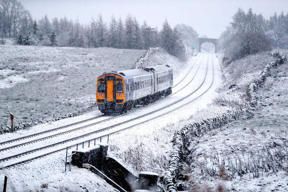 A train runs along the tracks in snowy North Yorkshire with the UK expecting more wintry weather ahead of the first weekend of December, with warnings in place for ice and snow.