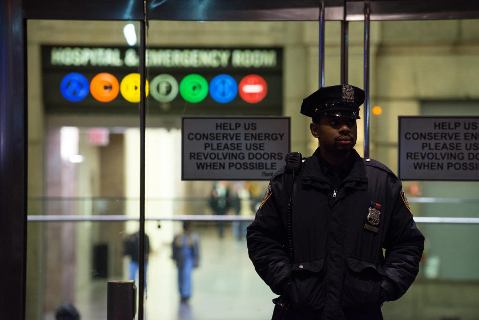 A New York City Police officer stands at the entrance to Bellevue Hospital October 23, 2014 in New York City.