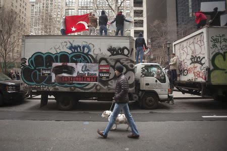 Protesters stand on a truck as they take part in a protest against the Turkish Government for issuing an arrest warrant for U.S.-based Muslim cleric Fethullah Gulen in the Manhattan borough of New York, December 20, 2014. REUTERS/Carlo Allegri