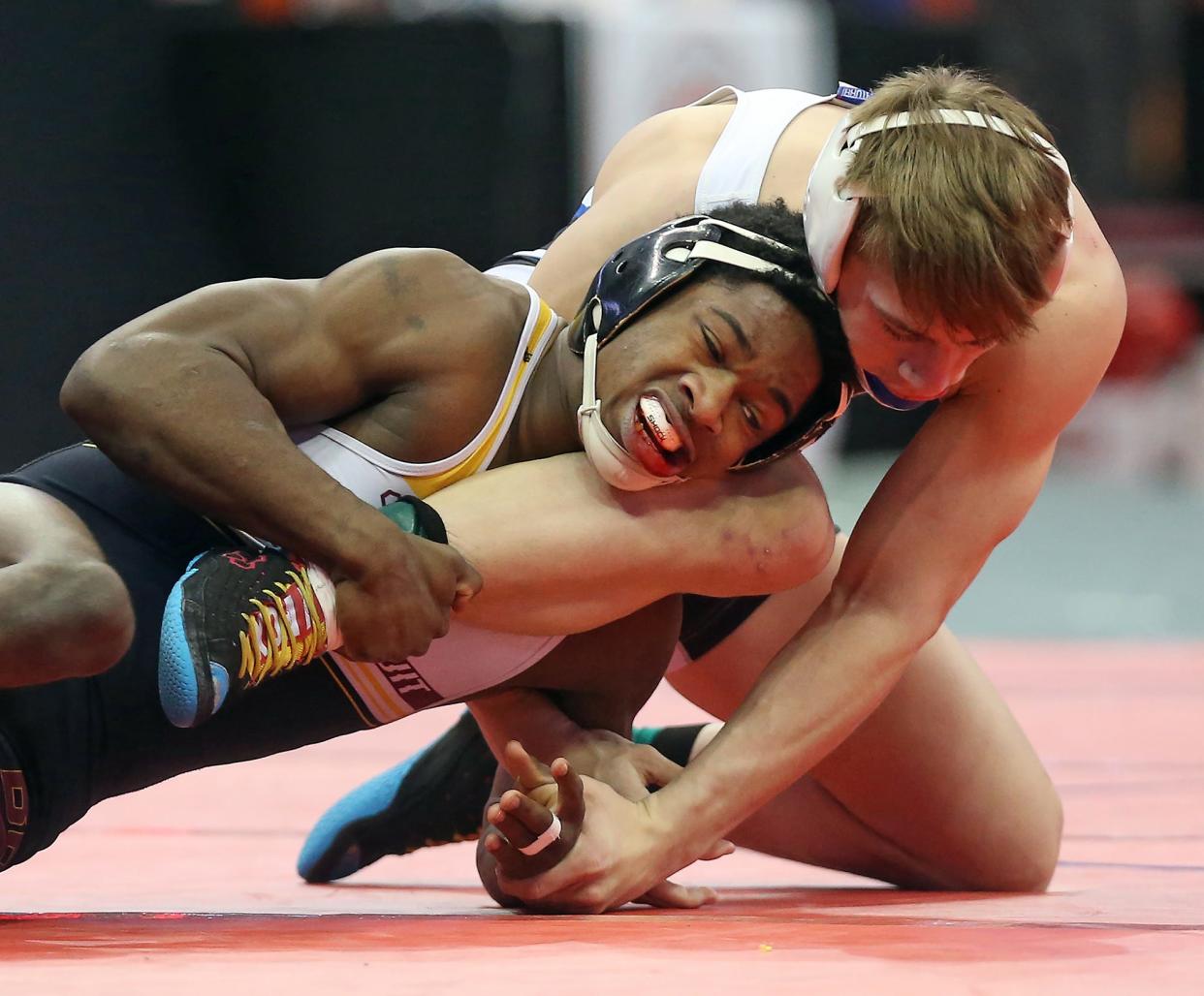 Walsh Jesuit's Dy'Vaire VanDyke, left, works the leg of Springboro's Conner Kleinberg during their 138-pound match in the Division I quarterfinal round of the State Wrestling Tournament Saturday at the Schottenstein Center. [Jeff Lange/Beacon Journal]