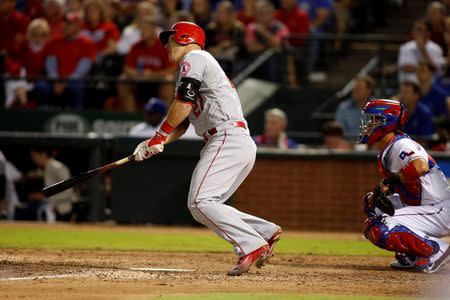 Oct 2, 2015; Arlington, TX, USA; Los Angeles Angels center fielder Mike Trout (27) hits a triple in the ninth inning against the Texas Rangers at Globe Life Park in Arlington. Los Angeles won 2-1. Mandatory Credit: Tim Heitman-USA TODAY Sports