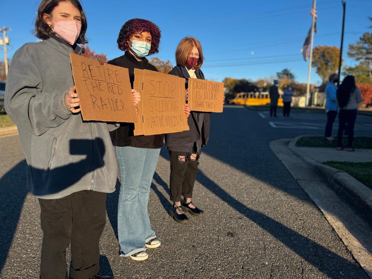 Students from Highland School of Technology, Lynabel Mercado, Ava Clarkson and Emily Rollins, take part in a recent protest outside the Gaston County Schools administrative building to encourage the board to stop the use of the Red Raider mascot at South Point High School.