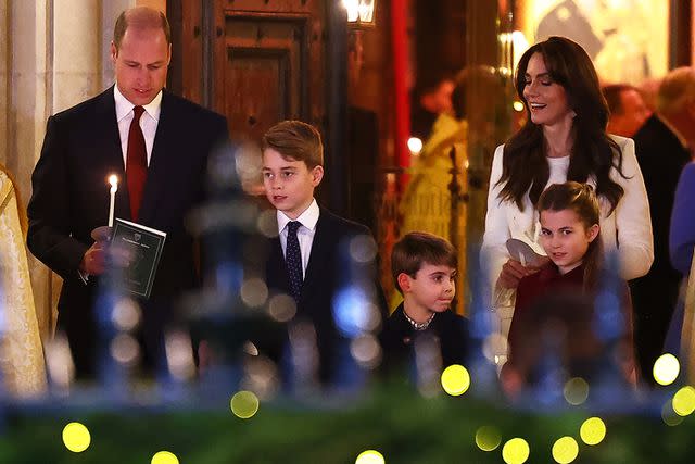 <p>HENRY NICHOLLS/AFP via Getty</p> Prince William, Prince George, Prince Louis, Kate Middleton and Princess Charlotte attend Christmas concert on Dec. 8, 2023