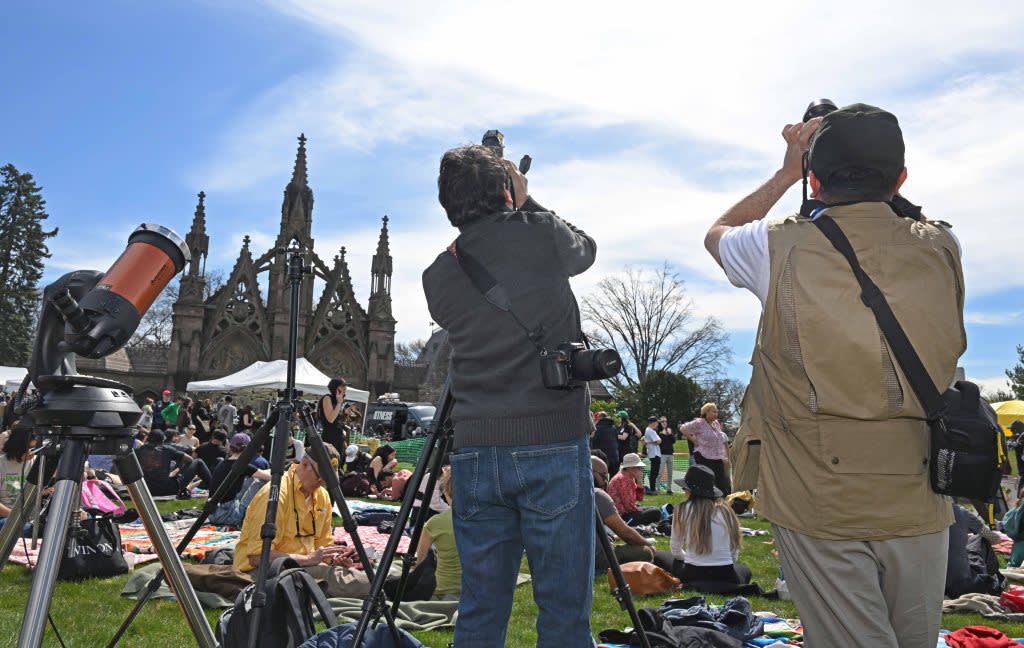 Cheer and joy radiated from Brooklyn’s Green-Wood Cemetery as residents waited for the solar eclipse on Monday. Gregory P. Mango