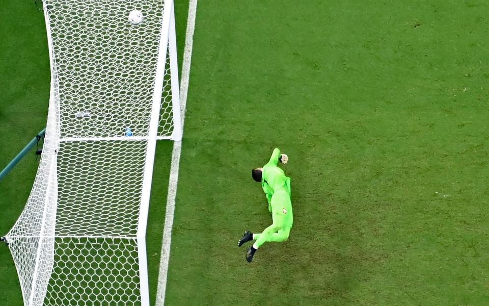 Poland's goalkeeper Wojciech Szczesny dives for the ball but fails to stop the shot from France's forward Kylian Mbappe - AFP via Getty