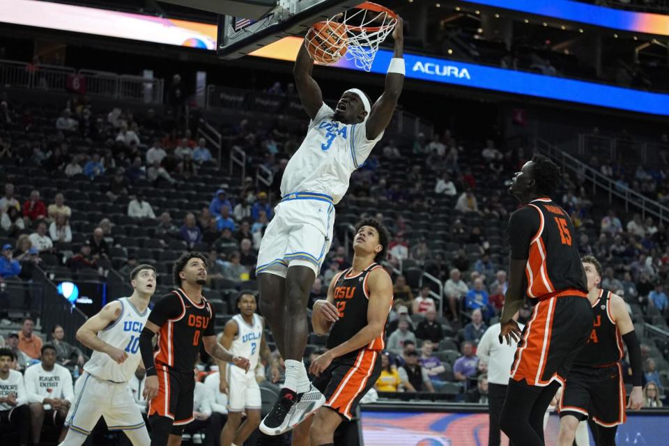 UCLA forward Adem Bona dunks against Oregon State in the first round of the Pac-12 tournament on Wednesday.