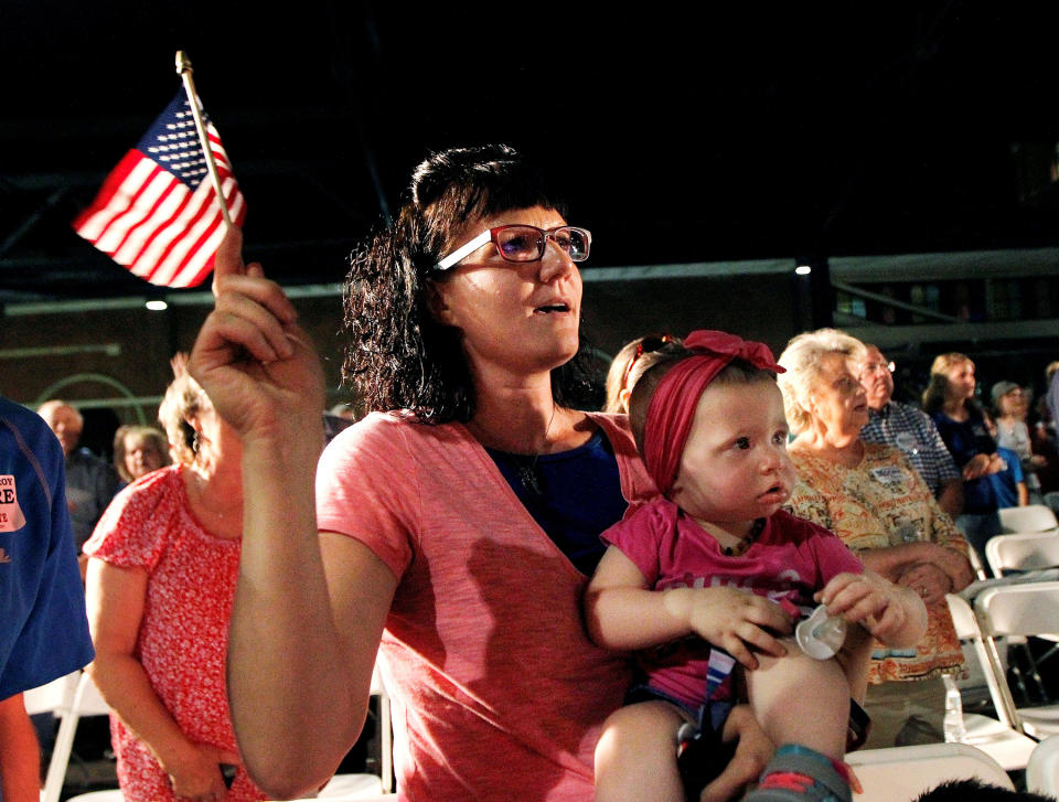 A supporter waves a flag as she listens to U.S. Senate candidate Judge Roy Moore, September 21, 2017.