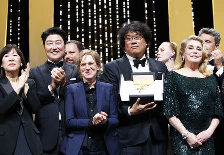 72nd Cannes Film Festival - Closing ceremony - Cannes, France, May 25, 2019. Director Bong Joon-ho, Palme d'Or award winner for his film "Parasite" (Gisaengchung), reacts with Jury members and Catherine Deneuve. REUTERS/Stephane Mahe