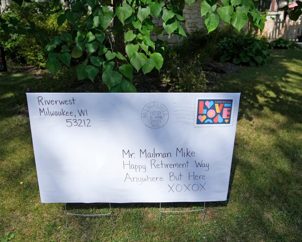 A sign is made posted in a year along the route of United States Postal Services carrier, Michael Boothe known as “Mailman Mike” in the Riverwest neighborhood near the corner of East Burleigh Street and North Dousman Street in Milwaukee on Friday, Sept. 22, 2023. Boothe is retiring after delivering mail along the same route for 30 years.