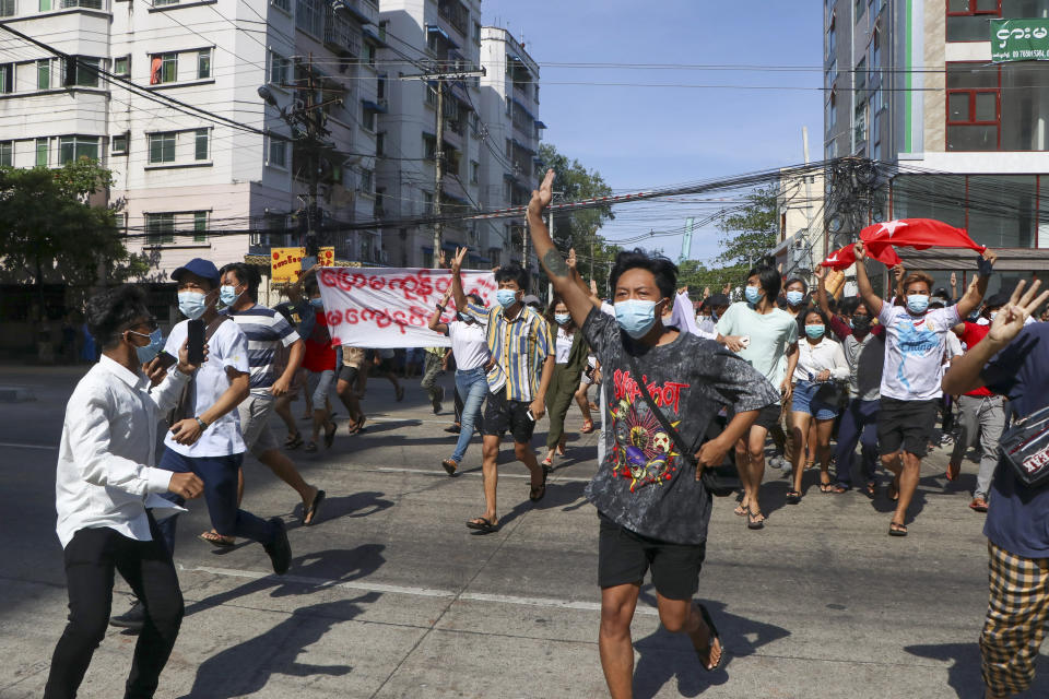 Anti-coup protesters flash the three-finger salute during a demonstration in Yangon, Myanmar, Friday, May 14, 2021. (AP Photo)