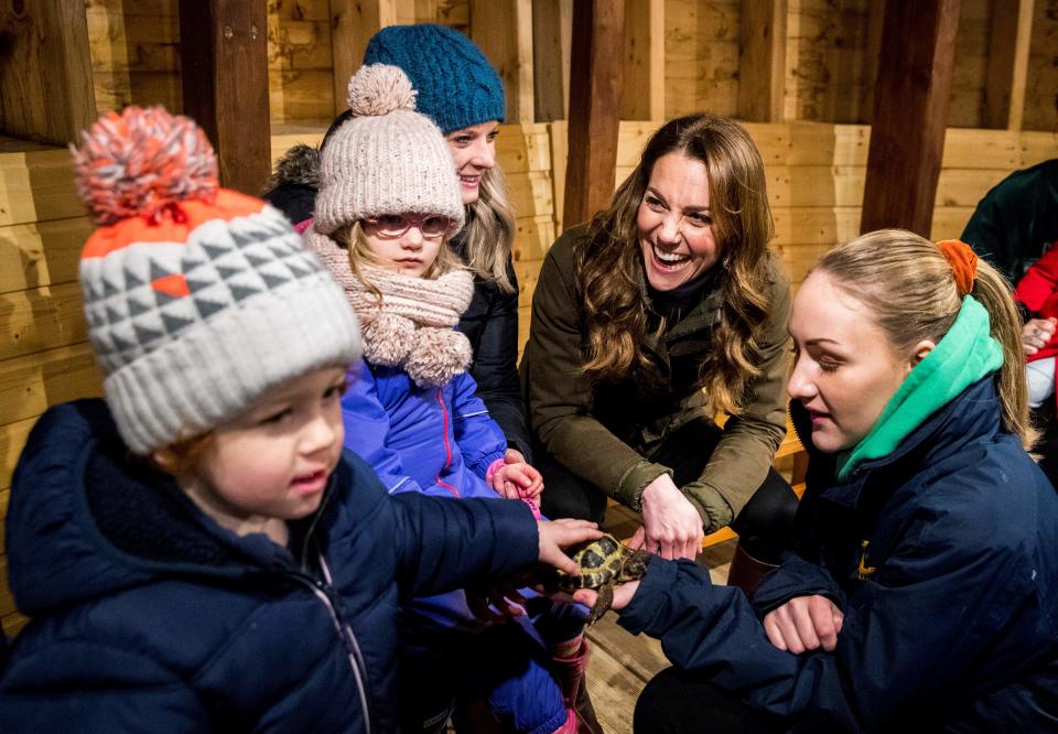 Britain's Catherine, Duchess of Cambridge (2R) reacts as she helps children bottle-feed a lamb during her visit to Ark Open Farm near Belfast on February 12, 2020, as part of her tour of the UK to promote her landmark survey on the early years, '5 Big Questions on the Under-Fives'. (Photo by Liam McBurney / POOL / AFP) (Photo by LIAM MCBURNEY/POOL/AFP via Getty Images)