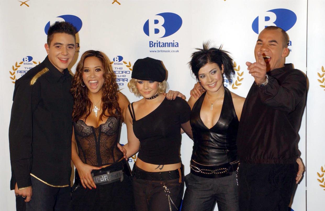 Pop group Hear'Say (from left) Noel Sullivan, Myleene Klass, Suzanne Shaw, Kym Marsh and Danny Foster pose for the media backstage at the Britannia Record of the Year ceremony at the London Television Centre.   (Photo by Yui Mok - PA Images/PA Images via Getty Images)