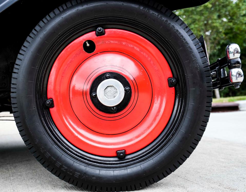 The bright red disk wheels are an upscale feature of Robert Cunningham's 1932 American Austin Bantam roadster.