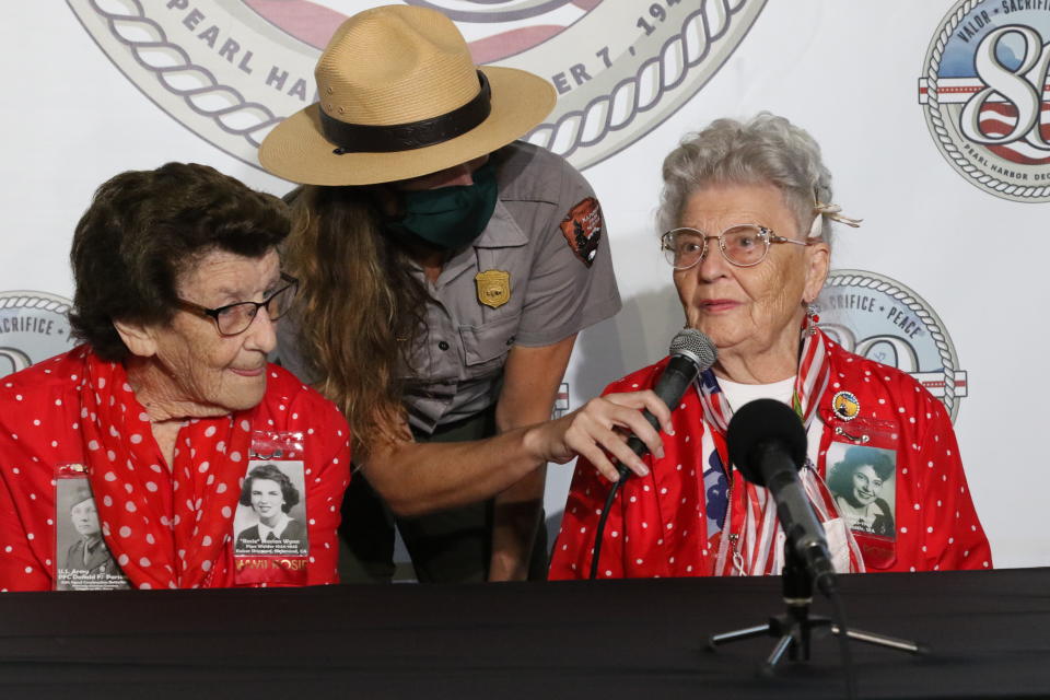 Mae Krier, right, who worked at a Boeing plant during World War II making B-17s and B-29s, speaks at a news conference in Pearl Harbor, Hawaii on Sunday, Dec. 5, 2021 accompanied by Marian Wynn, left, who worked as a pipe welder during the war. A few dozen survivors of Pearl Harbor are expected to gather Tuesday, Dec. 7 at the site of the Japanese bombing 80 years ago to remember those killed in the attack that launched the U.S. into World War II. (AP Photo/Audrey McAvoy)