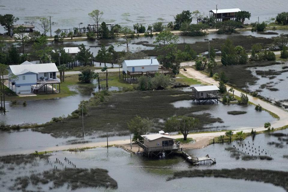 In this photo made in a flight provided by mediccorps.org, receding storm waters surround homes in Keaton Beach, Fla., following the passage of Hurricane Idalia in 2023.