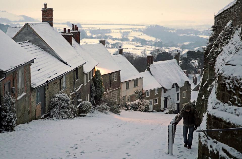 Snow covers houses in Gold Hill, in Shaftesbury, Dorset (PA)