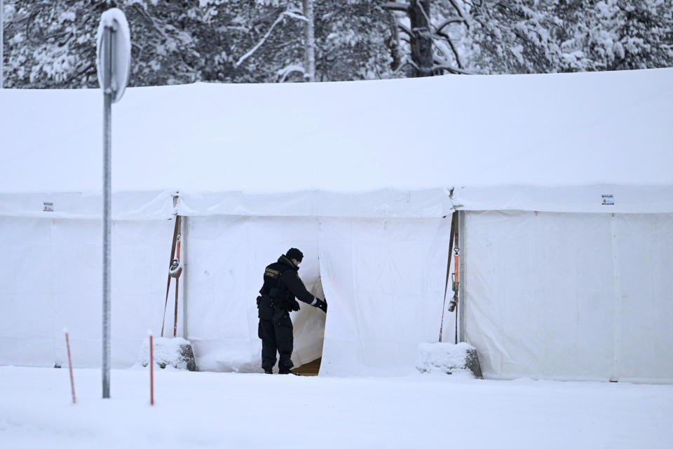 A border guard enters a heated tent reserved for possible migrants, at the Raja-Jooseppi international border crossing station with Russia, in Inari, northern Finland, on Tuesday, Nov. 28, 2023. Finland will close its last remaining road border with Russia due to concerns over migration, Prime Minister Petteri Orpo said Tuesday, accusing Moscow of undermining Finland's national security. Finland already closed seven of its eight of the checkpoints along its long border Russia this month following a surge in arrivals of migrants from the Middle East and Africa. The government accuses Moscow of ushering the migrants toward the Finnish border. (Emmi Korhonen/Lehtikuva via AP)