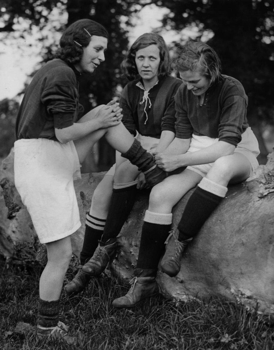 1934: hree women taking part in a training session for a football match which will take place during a fete on Whit Monday at Maidstone, Kent (Getty Images)