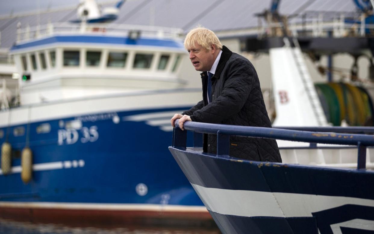 Prime Minister Boris Johnson looks on from aboard the Opportunis IV fishing trawler during a visit to Peterhead in Scotland  -  AFP