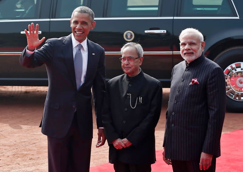 U.S. President Obama waves to the media as his Indian counterpart Mukherjee and Indian PM Modi watch during Obama?s ceremonial reception in New Delhi