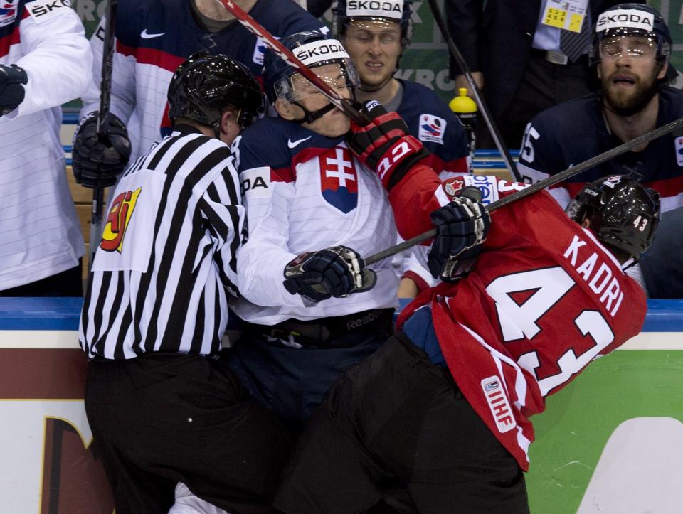 Canada's Nazem Kadri hits Slovakia's Marek Daloga with a high stick during second period action at the IIHF Ice Hockey World Championship in Minsk, Belarus, on Saturday, May 10, 2014. (AP Photo/The Canadian Press, Jacques Boissinot)