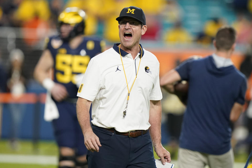 Michigan head coach Jim Harbaugh yells during warm ups before the Orange Bowl NCAA College Football Playoff semifinal game against Georgia, Friday, Dec. 31, 2021, in Miami Gardens, Fla. (AP Photo/Lynne Sladky)