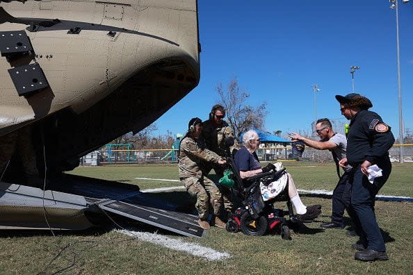 Francis Gersic is evacuated by a Florida Army National Guard chinook on October 2, 2022, in Pine Island, Florida. Residents are being encouraged to leave because the only road onto the island is impassable and electricity and water remain knocked out after Hurricane Ian passed through the area.