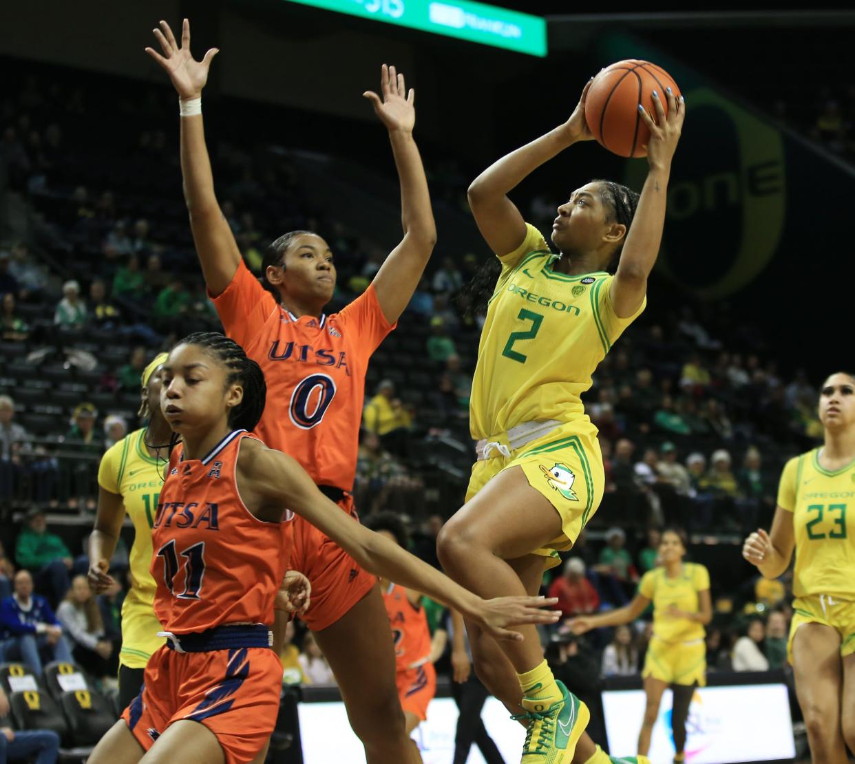 Oregon’s Chance Gray, right, shots over UTSA’s Sidney Love, left, and Elyssa Coleman during the second half at Matthew Knight Arena in Eugene Sunday, Dec 17, 2023.