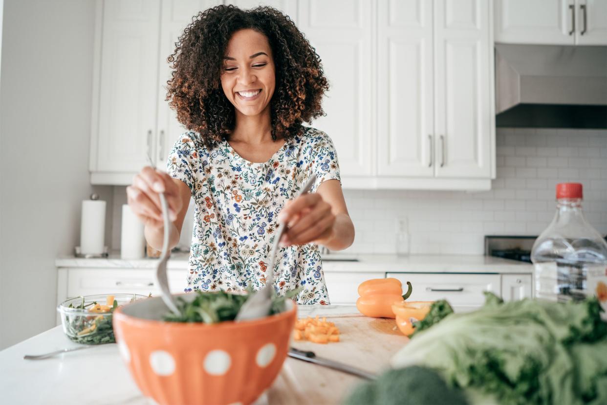 Woman preparing a salad in her kitchen