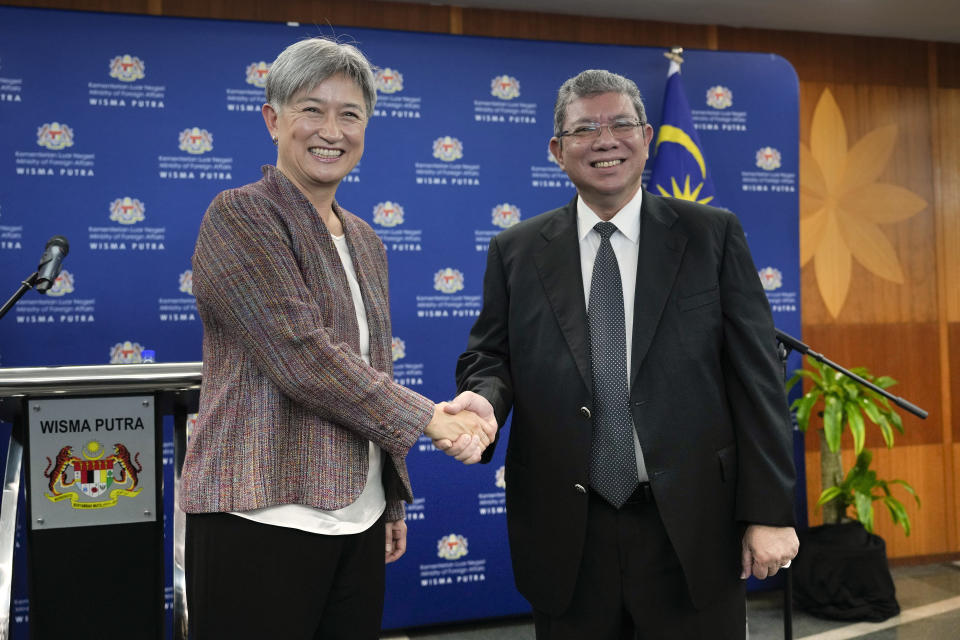 Australian Foreign Minister Penny Wong, left, shakes hands with Malaysian Foreign Minister Saifuddin Abdullah after a press conference in Putrajaya, Malaysia, Tuesday, June 28, 2022. (AP Photo/Vincent Thian)