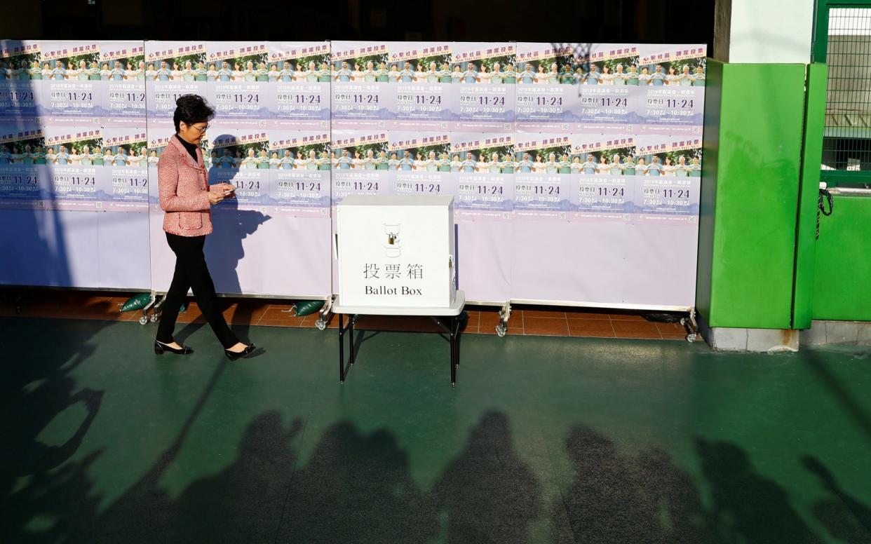 Hong Kong Chief Executive Carrie Lam casts her vote at a polling station during district council local elections - REUTERS