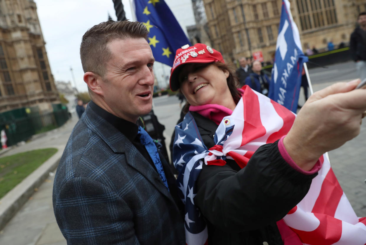 Far right activist Stephen Yaxley-Lennon, who goes by the name Tommy Robinson, poses for a selfie with a Donald Trump supporter, outside the Houses of Parliament in London, Britain, November 6, 2018. REUTERS/Simon Dawson