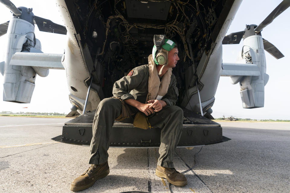 U.S. Marine Corps Lance Cpl. Brandon Oldham, waits to take off after aid was loaded onto a VM-22 Osprey at Toussaint Louverture International Airport, Saturday, Aug. 28, 2021, in Port-au-Prince, Haiti. The VMM-266, "Fighting Griffins," from Marine Corps Air Station New River, from Jacksonville, N.C., are flying in support of Joint Task Force Haiti after a 7.2 magnitude earthquake on Aug. 22, caused heavy damage to the country. (AP Photo/Alex Brandon)