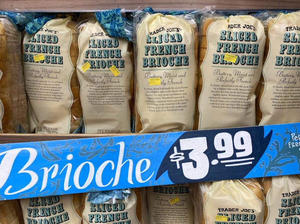 Loaves of brioche on a shelf at Trader Joe's with a blue $3.99 price tag