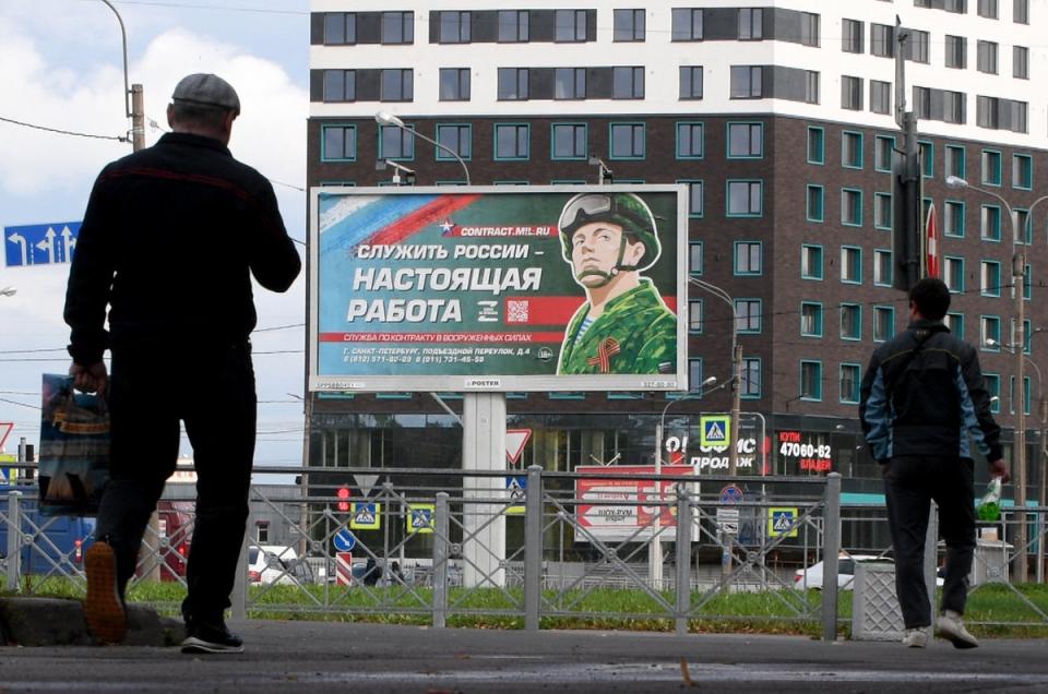 A billboard promoting contract army service with an image of a serviceman and the slogan reading 