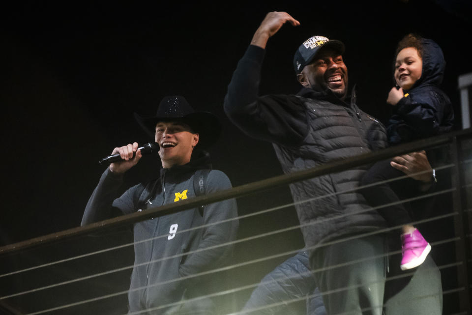 Michigan quarterback J.J. McCarthy, left, reacts as hundreds of fans chant "one more year," as the football team returned to Ann Arbor, Mich., Tuesday night, Jan. 9, 2024, the day after a win over Washington in the NCAA College Football Playoff title game in Houston. (Katy Kildee/Detroit News via AP)