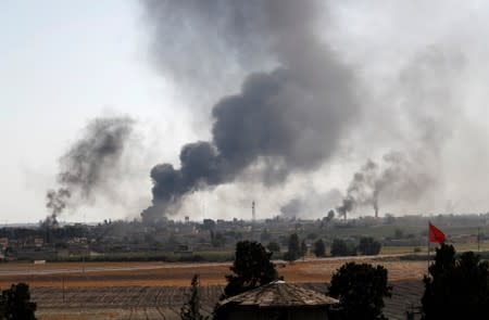 Smoke rises over the Syrian town of Tel Abyad, as seen from the Turkish border town of Akcakale