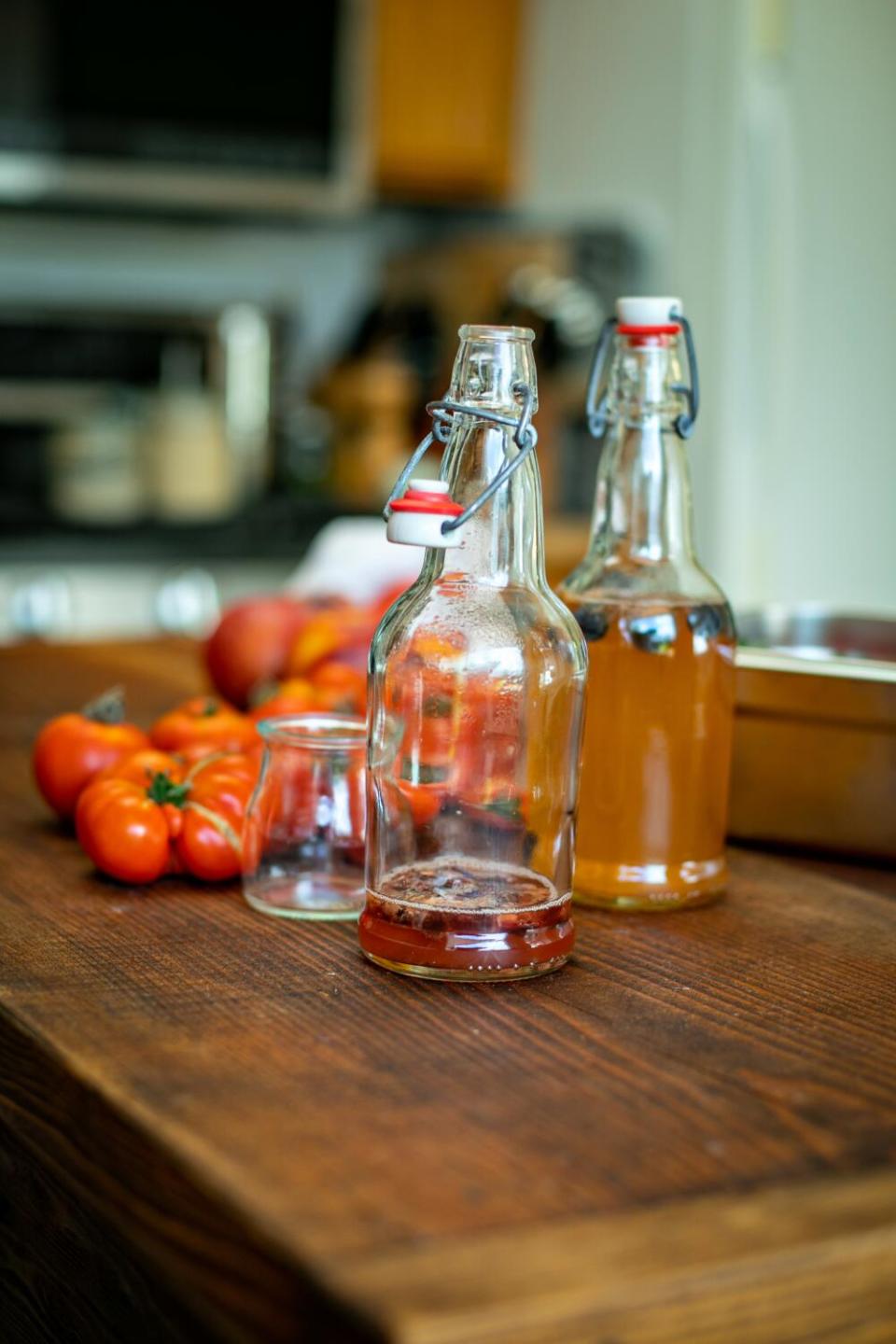 Anne-Marie Bonneau, the Zero Waste Chef, pours a glass of her homemade kombucha.