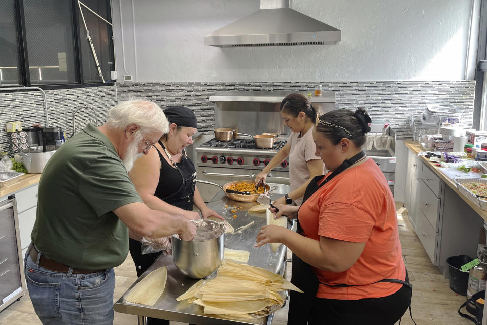 Volunteers at the American Indian Center of Chicago help chef Jessica Pamonicutt, second from left, prepare a contemporary Indigenous meal for seniors on Aug. 3, 2022. A fusion of Southwestern and Northern Indigenous ingredients, the spread includes turkey tamales with cranberry-infused masa, Spanish rice with quinoa, elote pasta salad with chickpea noodles and glasses of cold lemonade. (Claire Savage/Report for America via AP)