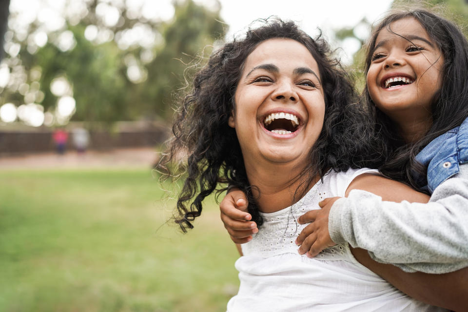 Happy indian mother laughing with her daughter 