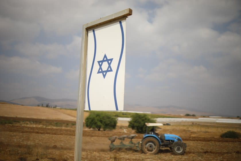 A Palestinian man works on a farm near Bardala, in the Israeli-occupied West Bank, Wednesday, Sept. 11, 2019. Israeli Prime Minister Benjamin Netanyahu's election eve vow to annex the Jordan Valley if he is re-elected has sparked an angry Arab rebuke and injected the Palestinians into a campaign that had almost entirely ignored them. (AP Photo/Ariel Schalit)