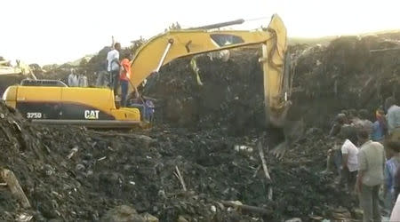 Excavators work after a landslide at a garbage dump on the outskirts of Addis Ababa, Ethiopia in this still image taken from a video from March 12, 2017. REUTERS/Reuters TV